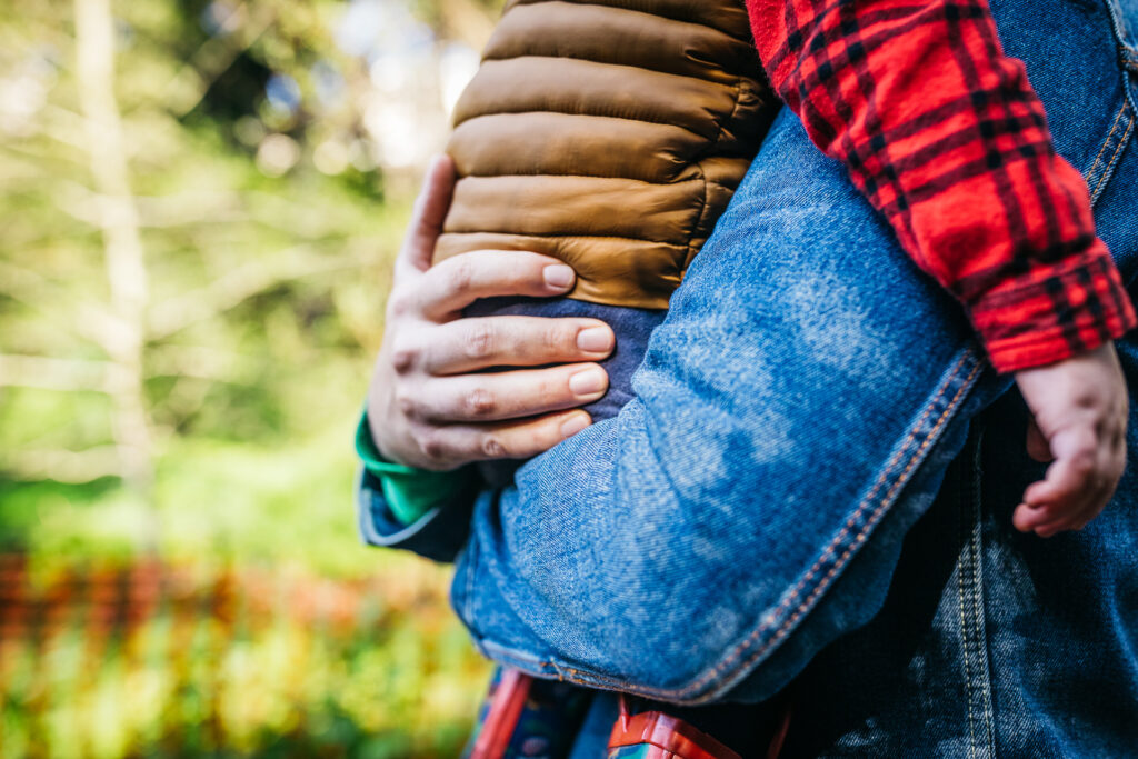 dad carrying son during a family session in oakland.