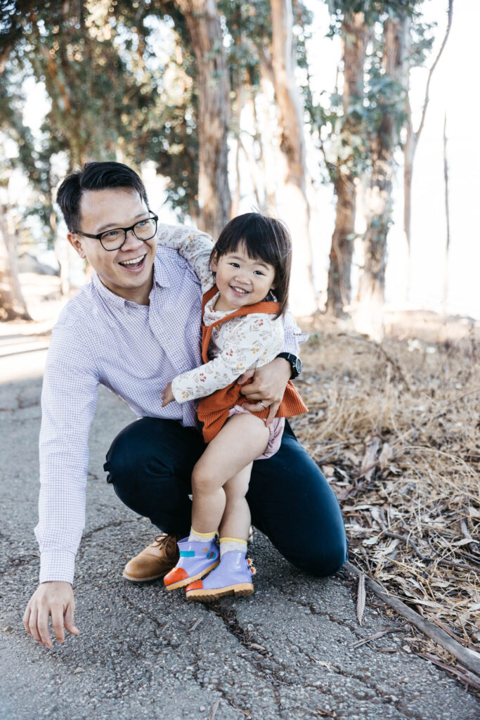 Father and daughter plays low to the ground on a trail at Coyote Point.