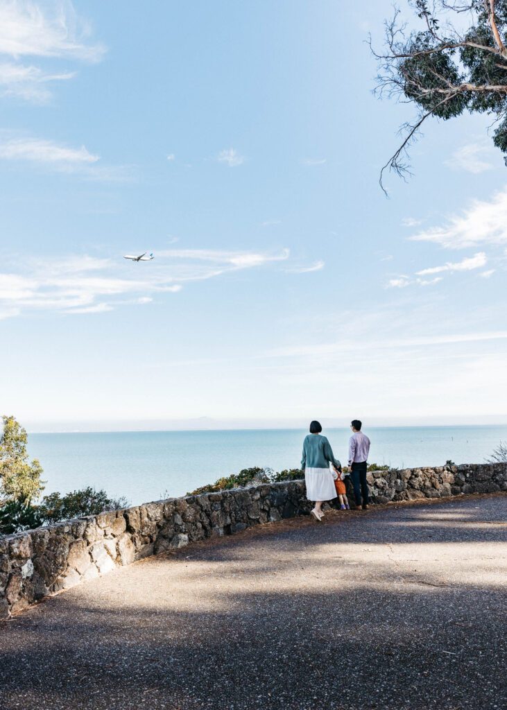 Wide shot of family viewing low-flying planes at Coyote Point.
