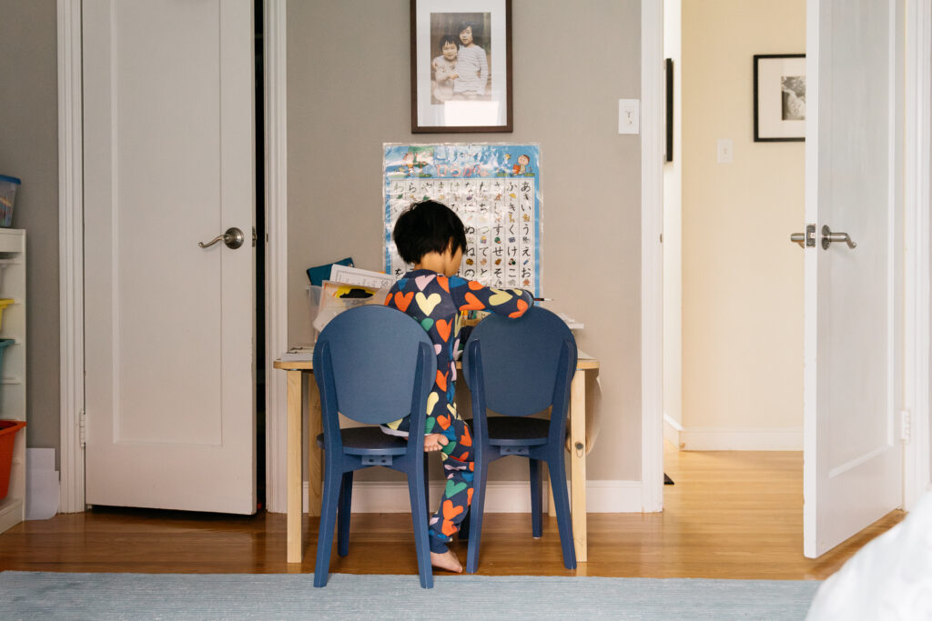 toddler boy drawing in his room during an in-home photo session in san francisco.
