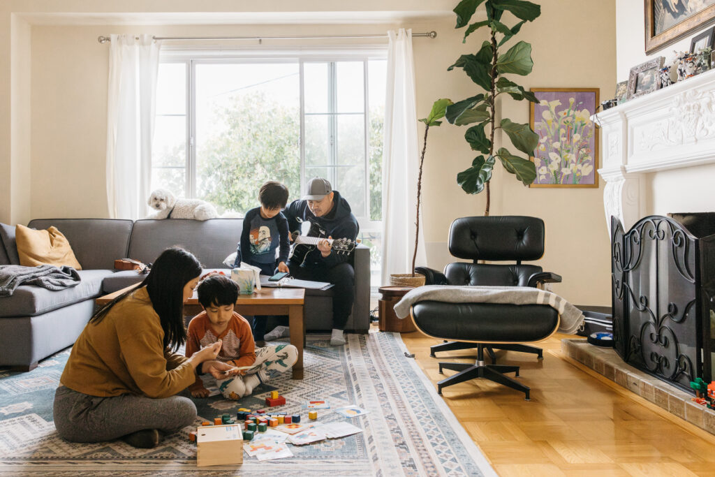 family playing together in the living room during a family photo session.