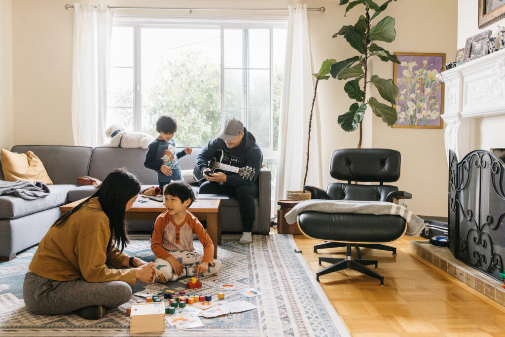 family playing together in the living room during a family documentary photo session.