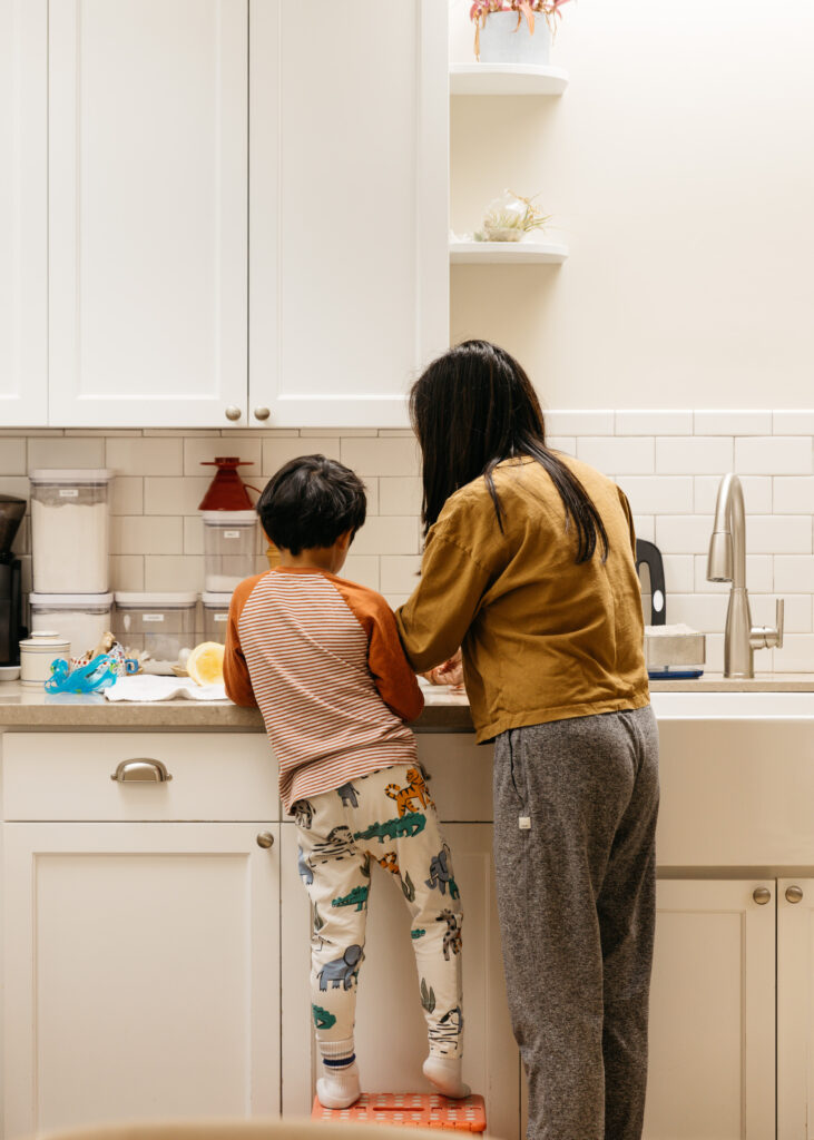 mom and son preparing breakfast together in the kitchen.