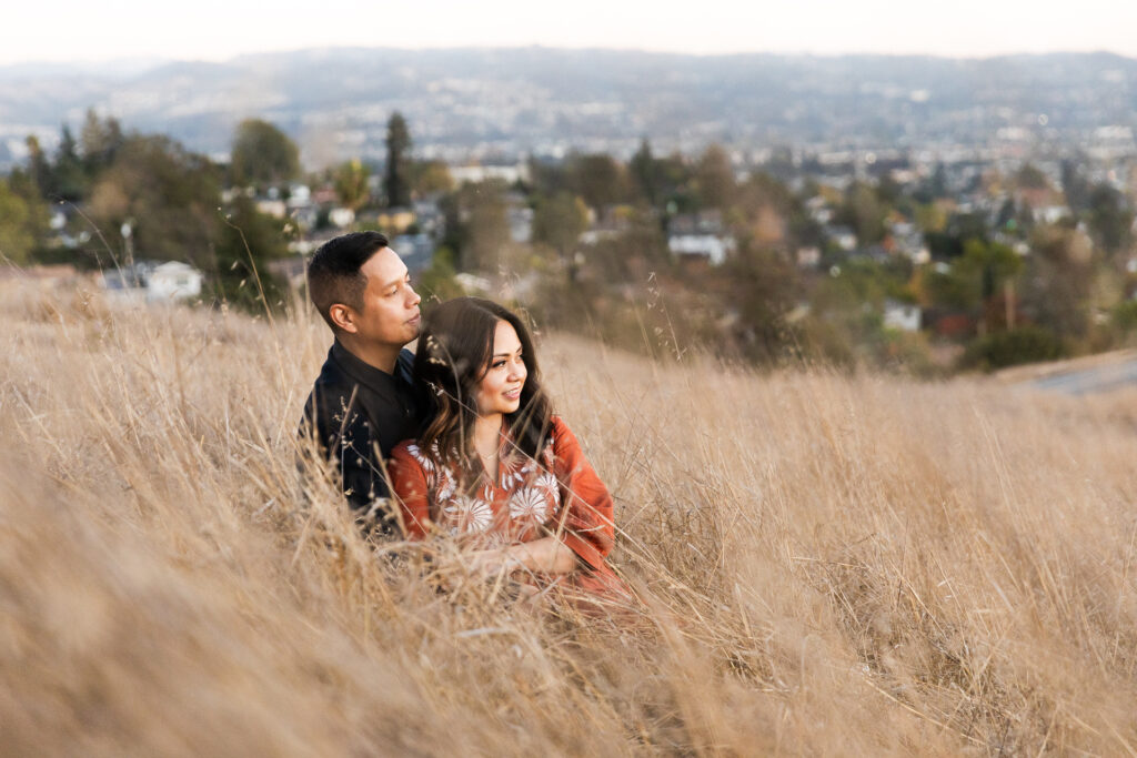 IMG_0224-Lake-Chabot-Castro-Valley-Family-Photographer-Carmen-Dunham-Photography A couple sitting in the tall grasses on the hillside of Lake Chabot.
