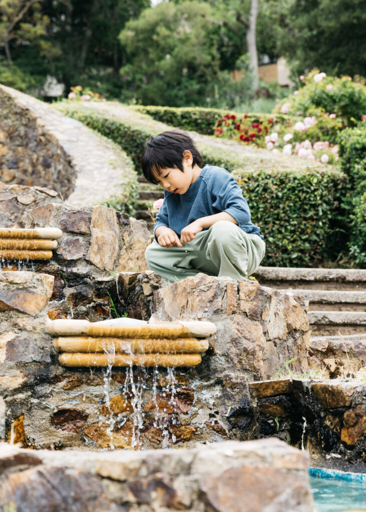 IMG_3551-Oakland-Morcom-Rose-Garden-Carmen-Dunham-Photography Boy looking at the water at the fountain in the Oakland Rose Garden.