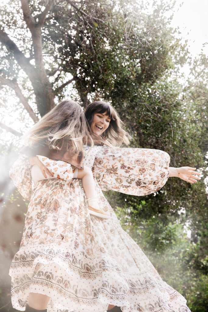 IMG_4464-Edit-Oakland-Family-Photographer-Carmen-Dunham-Photography Mom dancing while holding daughter at the Oakland Rose Garden.