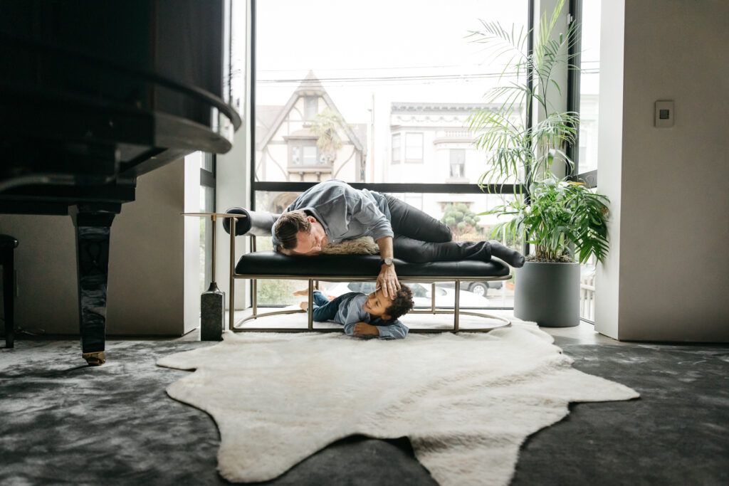 dad touching son's head in the living room
