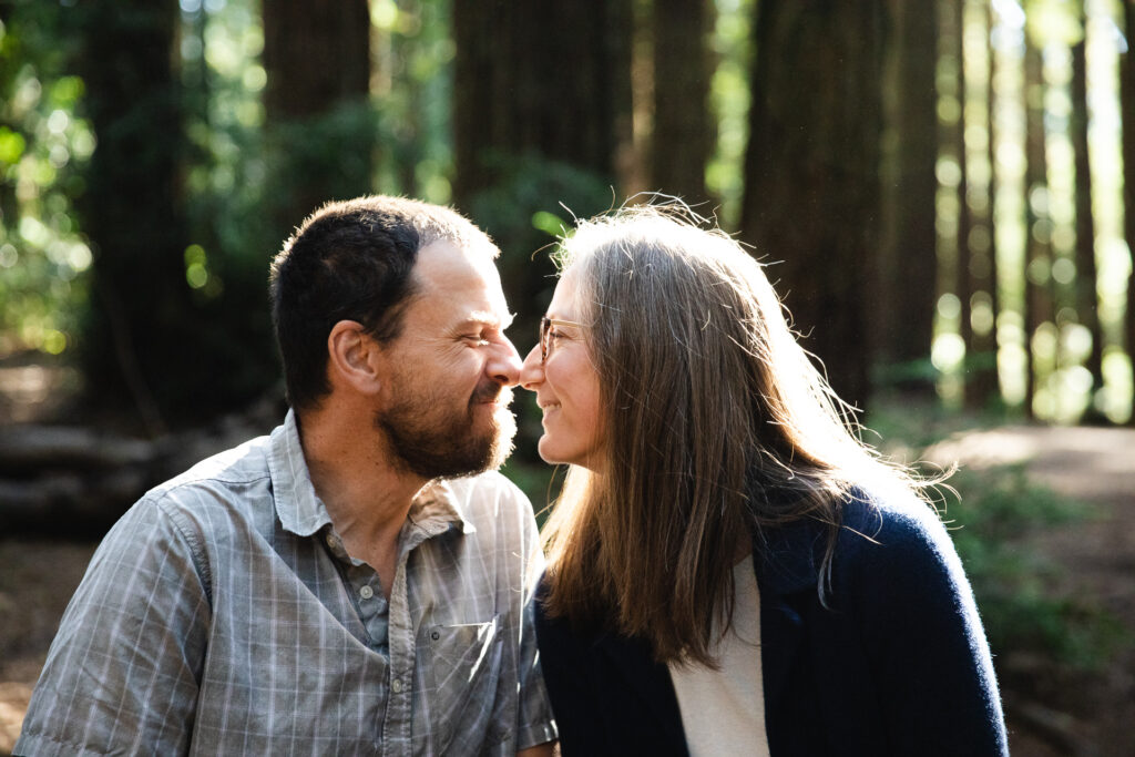 IMG_6675-Oakland-Joaquin-Miller-Family-Photography-Session-Carmen-Dunham-Photography Parents pressing their noses together at the Redwoods Grove in Oakland.