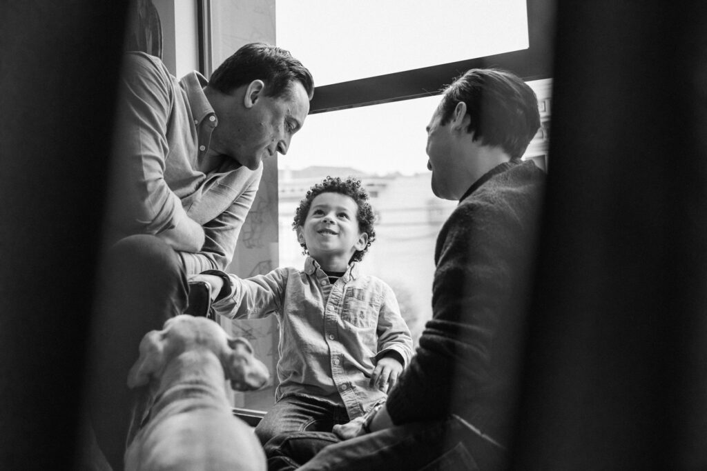 family playing near a bedroom window
