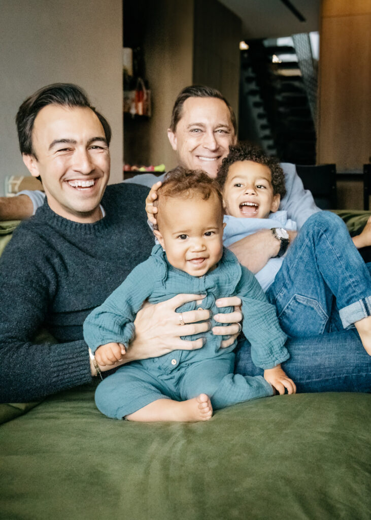 dads playing with family on the sofa in the living room in san francisco