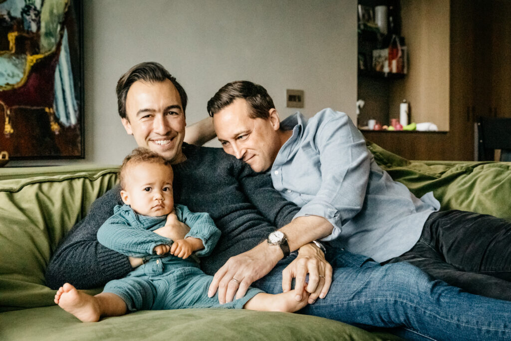 family cuddling on the sofa during an in-home family photo session in san francisco.