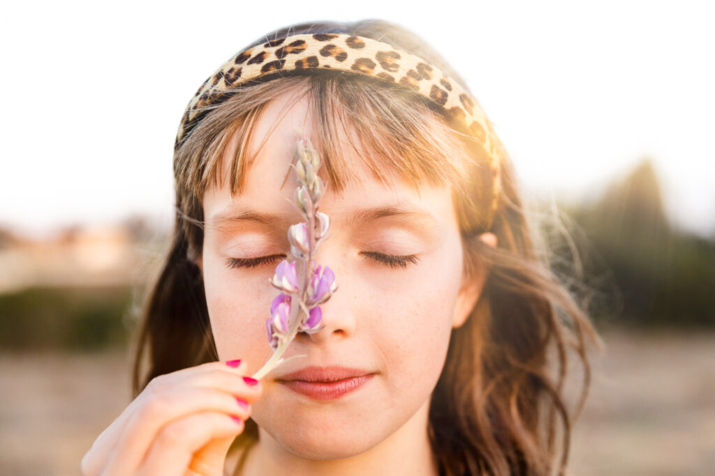 IMG_8746-Edit-Lake-Chabot-Castro-Valley-Family-Photographer-Carmen-Dunham-Photography Young girl closing her eyes while smelling a flower.