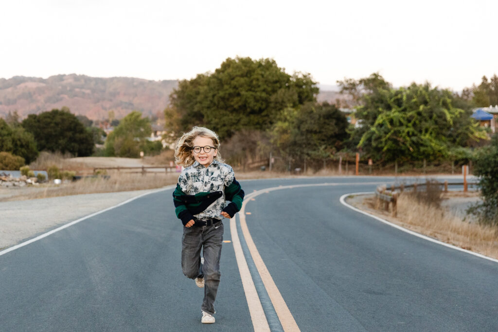 IMG_8752-Lake-Chabot-Castro-Valley-Family-Photographer-Carmen-Dunham-Photography Young boy running on the roadside at Lake Chabot.