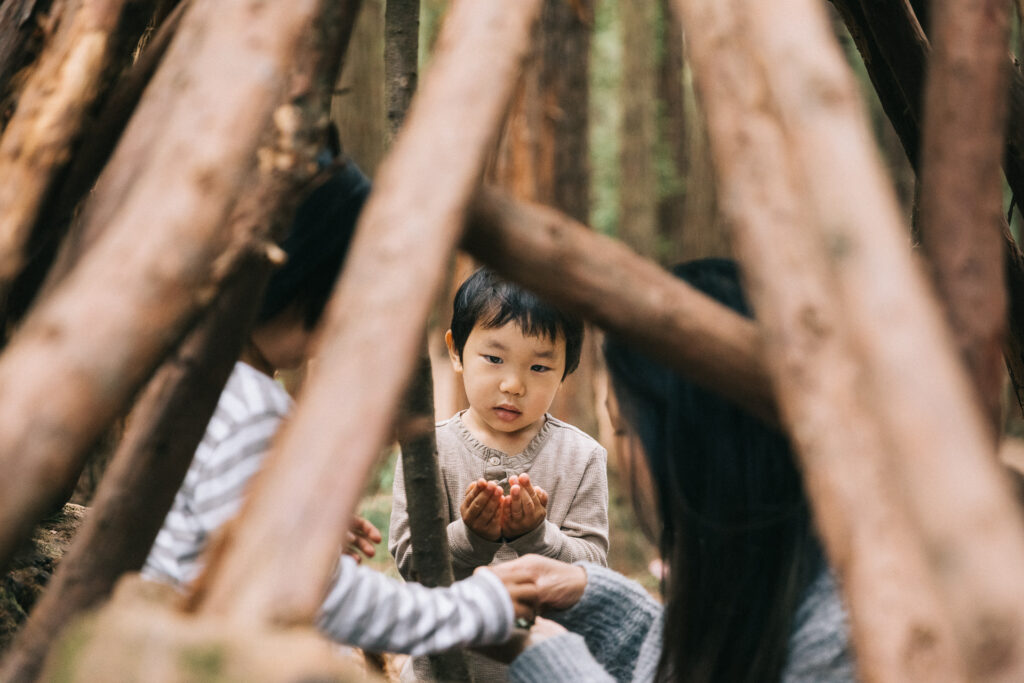IMG_9115-Oakland-Joaquin-Miller-Family-Photography-Session-Carmen-Dunham-Photography Boy playing in a teepee at Joaquin Miller Park.