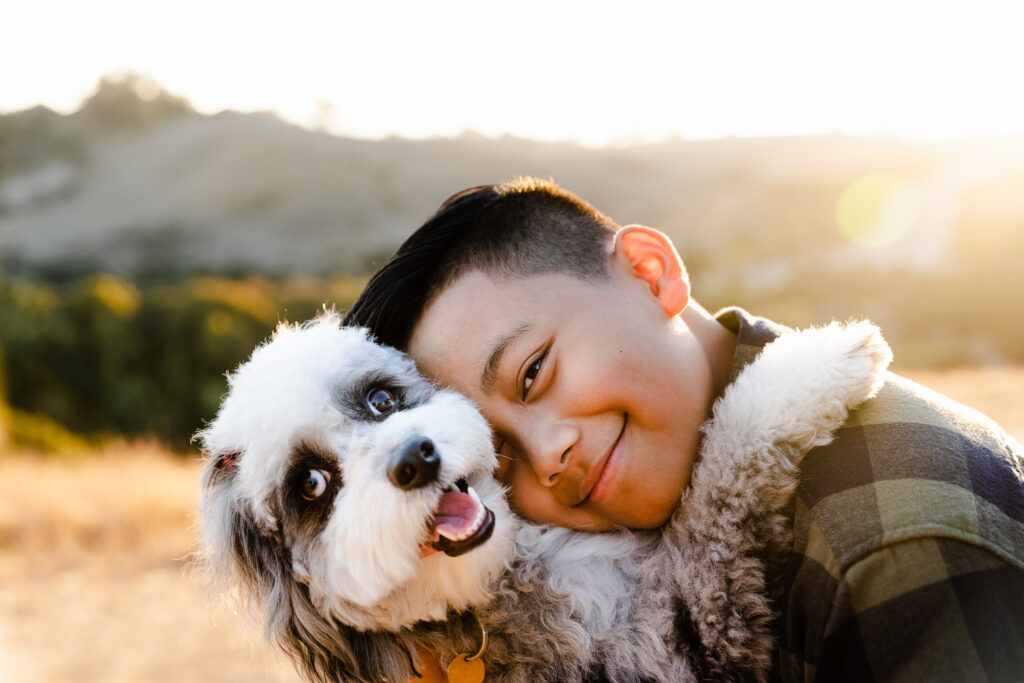 IMG_9965-Edit-Lake-Chabot-Castro-Valley-Family-Photographer-Carmen-Dunham-Photography Young boy hugging his puppy during a family photo session at Lake Chabot.