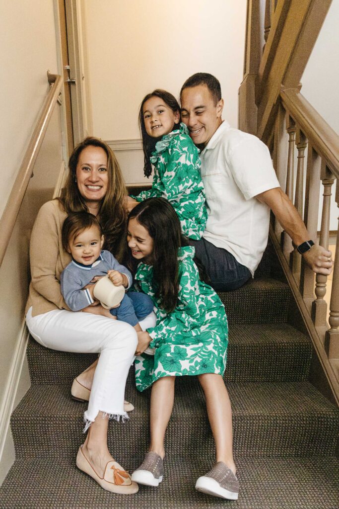 Family gathers for one last photo on the main stairwell of their apartment building.