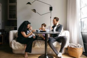 Mom and dad are having breakfast with their toddler boys during a family photo session at home in San Francisco.