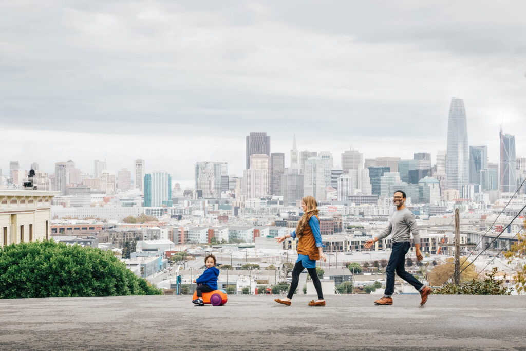 Family walk in their
neighborhood with the San Francisco skyline in the background.
