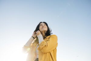 Graduating senior is adjusting her hair during a photo session in the East Bay.