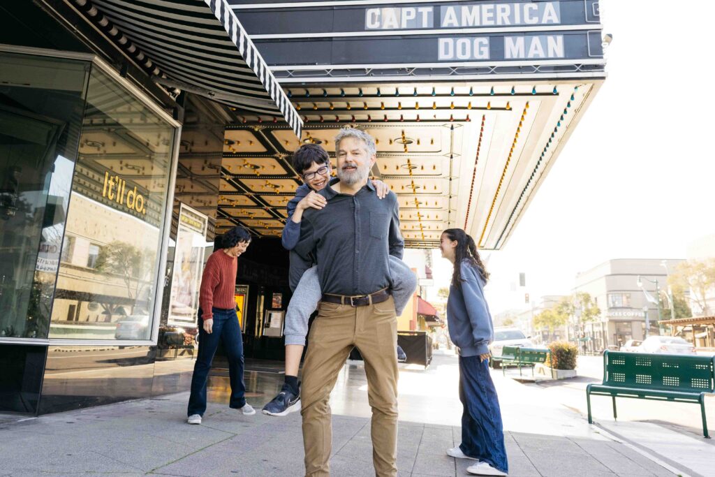 A family is goofing around in their downtown area of Alameda.