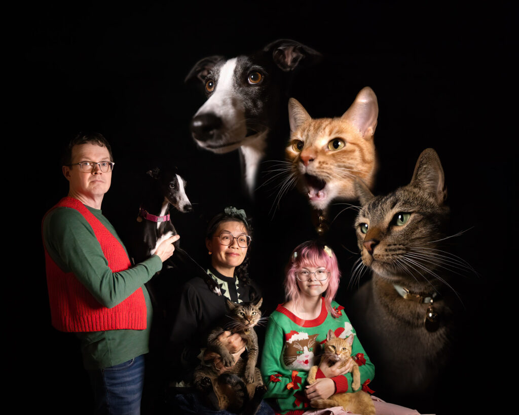 Satire of a retro family photo in studio with family and their pets which consist of two cats and a dog.