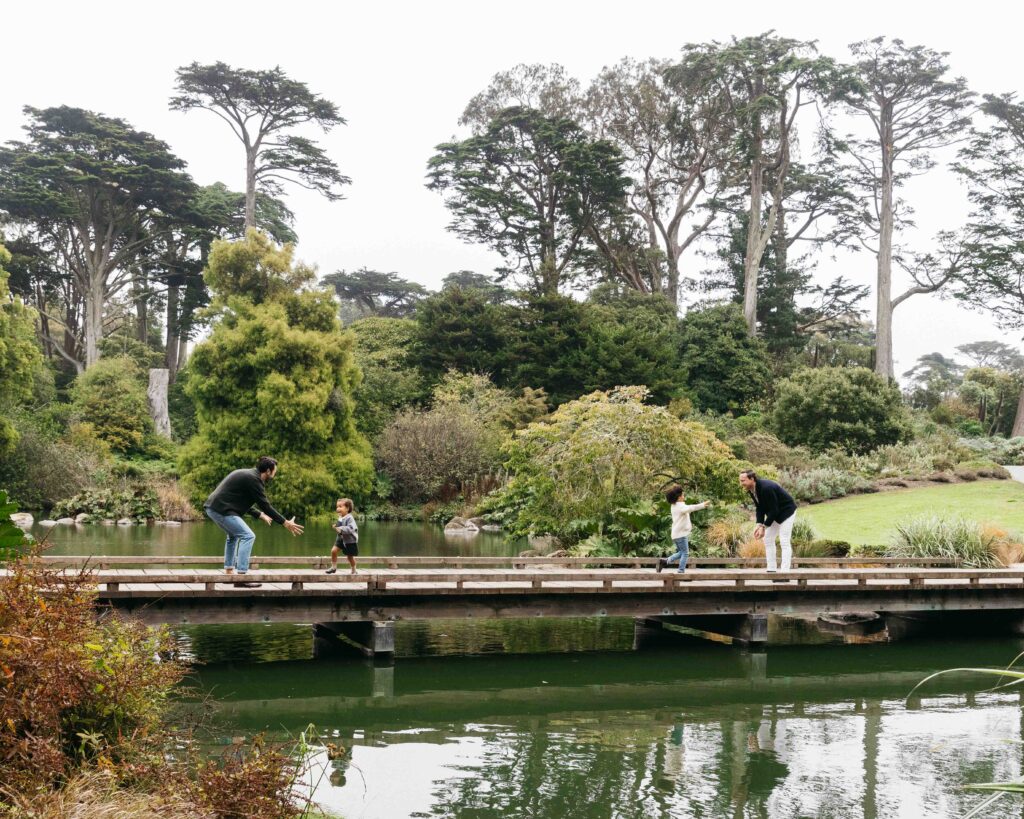Young siblings are running toward their parents.