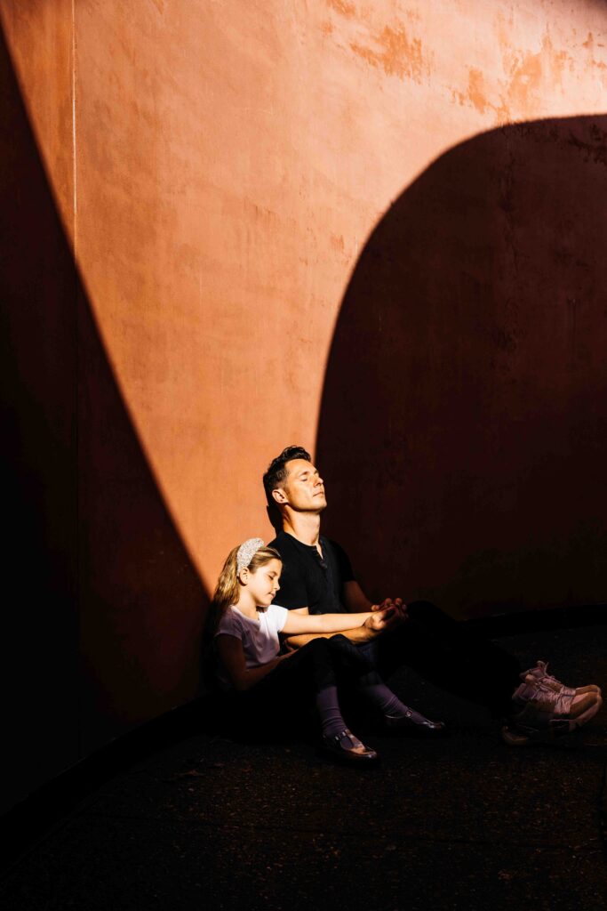 Dad and daughter are enjoying the sun on their faces at the Turrell Skyspace.