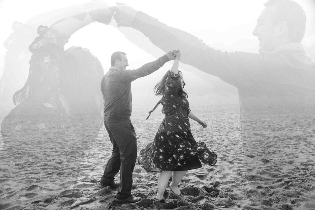 Husband and wife are dancing on the sand at Baker Beach.