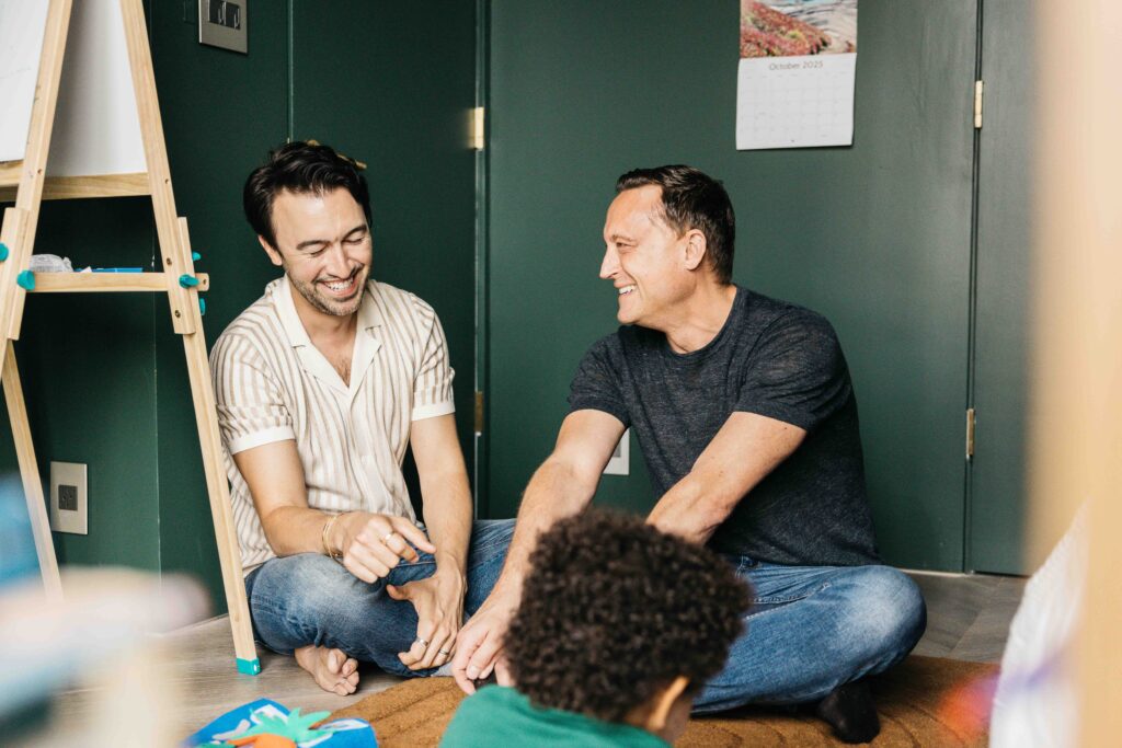 Dads are laughing at a story.