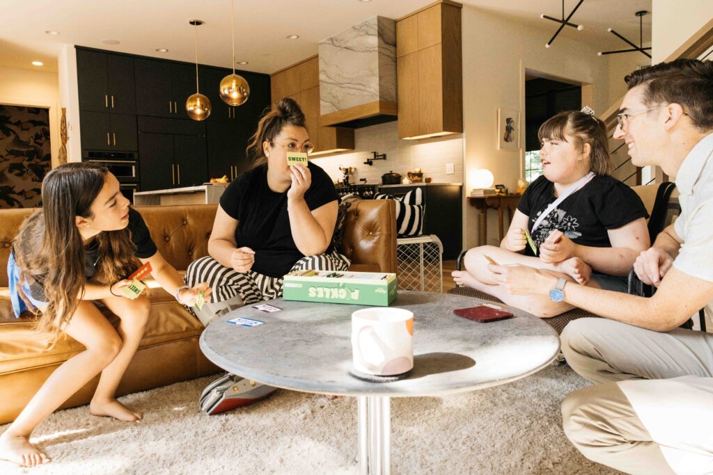 Family is playing a board game in their living room.