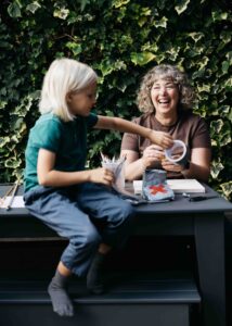 Mom and daughter are putting together a costume out of duct tape.