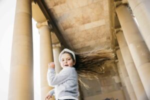 Young girl is dancing and singing on stage at the Music Concourse in Golden Gate Park.