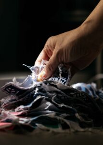 Fingers are combing through fabric swatches.