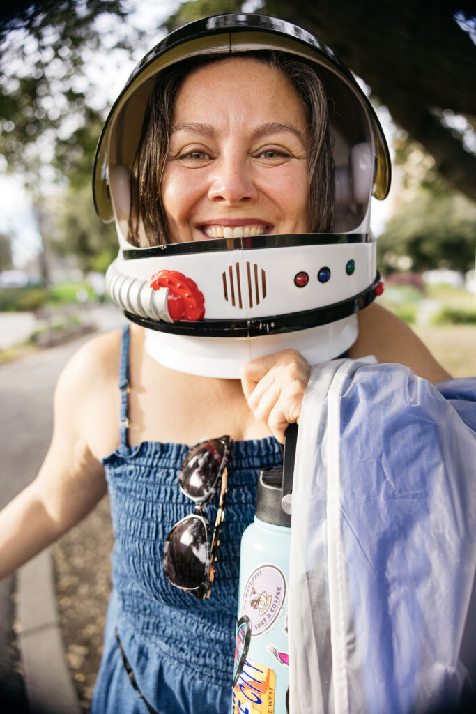 Mom is wearing an astronaut helmet to her son's senior session in Oakland.