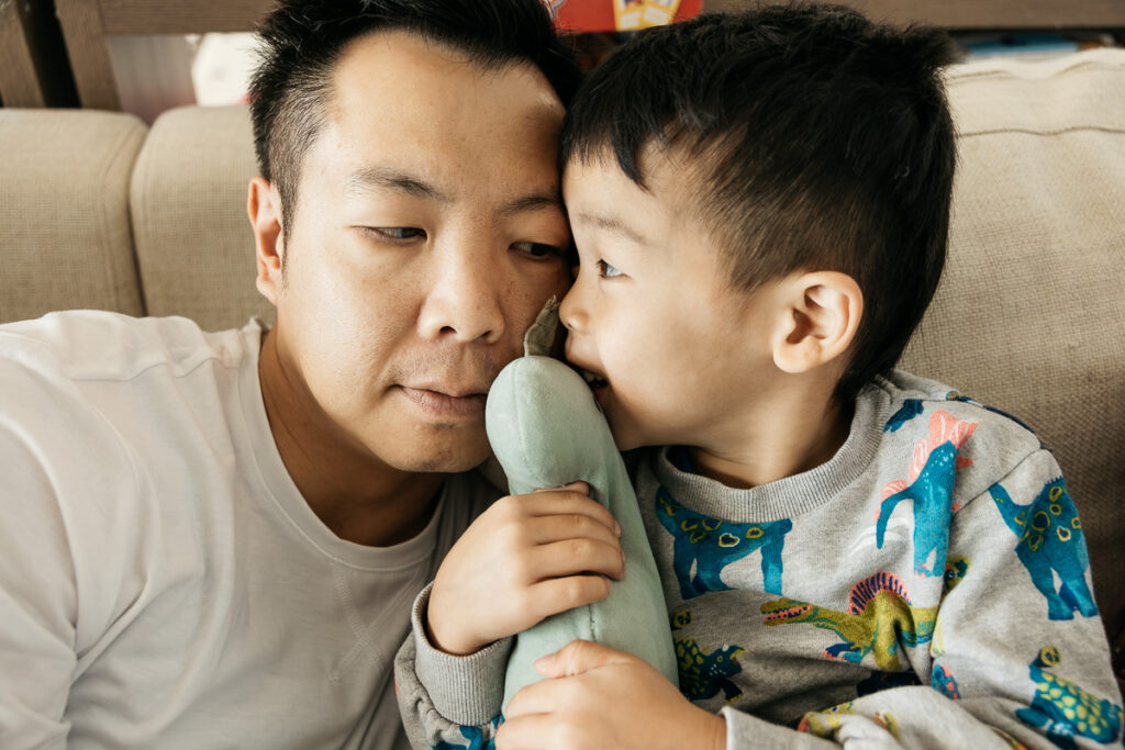 Dad is looking adoringly at his son during a family photo session with Carmen Dunham.